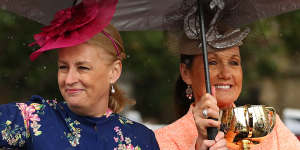 Lord mayor Sally Cap and VRC chair Amanda Elliott parade with the Melbourne Cup on Monday.