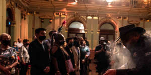 Brendan Kerin from the Metropolitan Local Aboriginal Land Council conducts a smoking ceremony at Town Hall on Thursday.