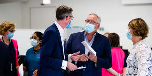 Premier Dominic Perrottet,Health Minister Brad Hazzard and NSW Health Deputy Secretary Susan Pearce at the opening of the Granville Centre vaccination clinic in western Sydney on Sunday.