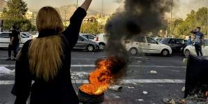 Iranians protest the death of 22-year-old Mahsa Amini after she was detained by the morality police,in Tehran in October 2022.