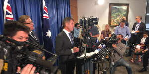 Premier Mike Baird at Tuesday's media conference announcing the reversal. 