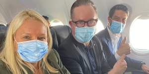 Happy with the middle seat in an early flight back in June:Qantas chief executive Alan Joyce,centre,with chief customer officer Steph Tully and Qantas International chief executive Tino La Spina.