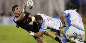 Loading up:Roelof Smith offloads during a tackle in the Jaguares'win over the Bulls.