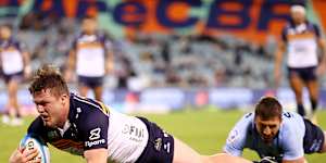 Billy Pollard of the Brumbies dives to score a try