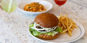 The barra burger with crumbed barramundi fillet,cos lettuce,white onion and a toasted milk bun.