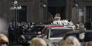 Military police gather outside the main entrance as an armoured vehicle rams into the door of the presidential palace in Plaza Murillo in La Paz,Bolivia.