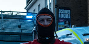 A man holds an English flag during the Epping protest.