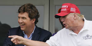 Tucker Carlson and Donald Trump watching a LIV golf event in New Jersey in July 2022.