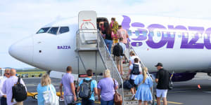 Passengers board the first Bonza flight on the Sunshine Coast on Tuesday morning.