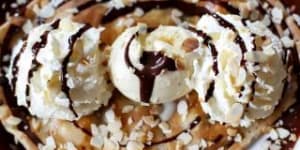 Colossal:Chocolate,banana,whipped cream,grilled almonds and vanilla ice cream crepe at Four Frogs Creperie.