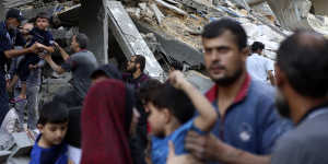 Palestinians evacuate families from their homes after an Israeli airstrike in Jabalia refugee camp on Sunday.