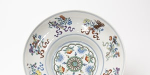 Wucai decoration on porcelain from the Qing Dynasty showing symbols of the eight Taoist Immortals. Once owned by Sir Keith Murdoch,the piece was bequeathed by his friends,Herbert and May Shaw,to the Hamilton Gallery.
