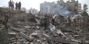 Palestinians inspect damage to a mosque and their homes in Gaza City following Israeli air strikes on Monday.