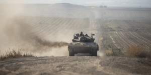 An Israeli tank moves a long the border with the Gaza Strip as seen from a position on the Israeli side of the border.