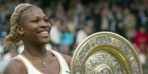 Serena Williams holds her trophy after winning her first Wimbledon title in 2002.