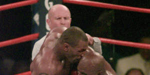 Mike Tyson bites off part of Evander Holyfield’s ear in their 1997 ‘bit fight’.