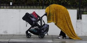 A homeless person shields themselves from the rain in Los Angeles. 