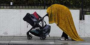A homeless person shields themselves from the rain in Los Angeles.