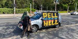 An anti-Pell protest car drives through the streets of Sydney.