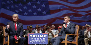 Then-presidential candidate Donald Trump gives a thumbs up as he speaks with Michael Flynn at a campaign event in 2016.