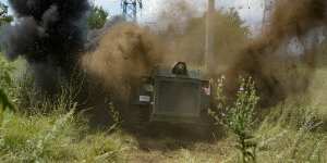 A Russian military robotic vehicle detonates a land mine on a mine clearing mission along the high voltage line in Mariupol.