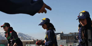 The Afghan women’s cricket team trains on a snow-covered Kabul Cricket Stadium.