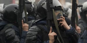 Riot police officers stand ready to stop demonstrators during a protest in Almaty,Kazakhstan.