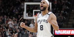 Patty Mills celebrates a basket against the Heat.