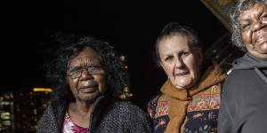 Artists Judith Inkamala,Marlene Gilson and Marlene Rubuntja with the projection of Aboriginal artist Kaylene Whiskey’s work ‘Dolly visits Indulkana’.