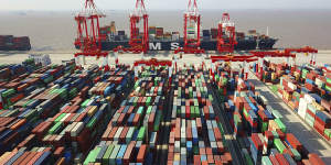 A trade war is dividing the US and China. A cargo ship is docked at the Yangshan container port in Shanghai,China. 