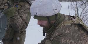 Ukrainian servicemen drawing water from a well near the front line wait for an invasion that US President Joe Biden thinks may come within weeks. 