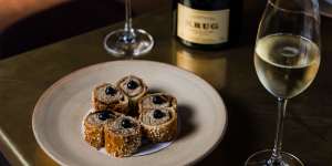Krug champagne paired with suckling pig sausage rolls at Bennelong in Sydney.
