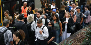 Commuters wait in a snaking line for B-line buses to the northern beaches at Wynyard station.