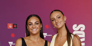 Monique Conti of the Tigers arrives with her sister Gabby Conti on Monday evening.