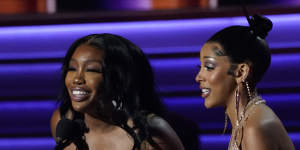 SZA,left,and Doja Cat accept the award for best pop duo/group performance for Kiss Me More at the Grammys. 