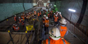 Construction workers near the tunnel boring machine named Nancy,which broke through at the new Pitt Street station on Friday.