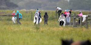 Potential illegal workers try to flee during a Border Force raid on Vizzarri Farms in Koo Wee Rup,Victoria.