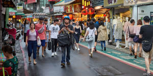 Tourists and locals walk around a night market in Taipei. Polls consistently show that young Taiwanese in particular,have no interest in reunification with China.