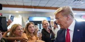 Much loved by Republicans,Trump greets fans at a Florida restaurant after his second indictment,in June.