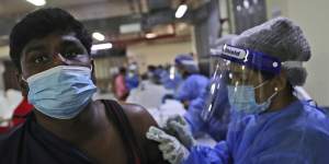 A man receives a Sinopharm COVID-19 vaccine from a medical staffer at the Guru Nanak Darbar Sikh Temple,in Dubai,United Arab Emirates.