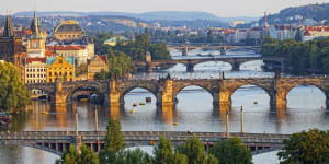  The Vltava River bridges shine in the setting sun.