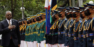 United States Defence Secretary Lloyd Austin walks past military guards during arrival honours at the Department of National Defence in Camp Aguinaldo.