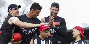 Brayden Maynard,Scott Pendlebury and Jeremy Howe with a couple of young fans who were Magpies team mascots for their preliminary final.