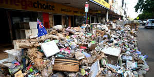 Piles of flood-damaged goods line a main street in central Lismore. 
