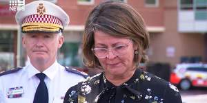 NSW Health Secretary Susan Pearce chokes back tears as she expresses her condolences to the paramedic’s wife and family.