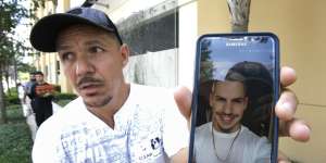 Angel Mendez,outside the Orlando Regional Medical Centre,holds up a phone photo trying to get information about his brother Jean C. Mendez who was at the Pulse Nightclub.