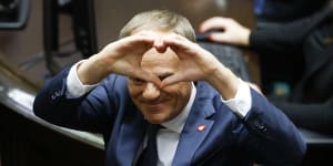 Donald Tusk shows a heart with his hands to lawmakers after he was elected as Poland’s prime minister in parliament in Warsaw on Monday.