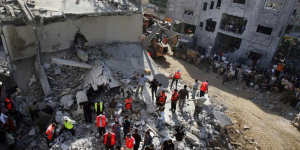 Palestinian rescuers search for survivors under the rubble of a Hamas house in Gaza City in 2006. Mohammed Deif was wounded in the attack and operated on.