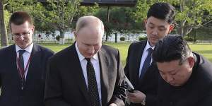 North Korean leader Kim Jong Un,right,presents a pair of Pungsan dogs to Russia’s President Vladimir Putin.