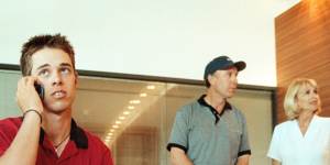 Aaron Baddeley doing an interview in his hotel foyer after winning the 1999 Australian Open,with parents Ron and Jo-Ann in the background.